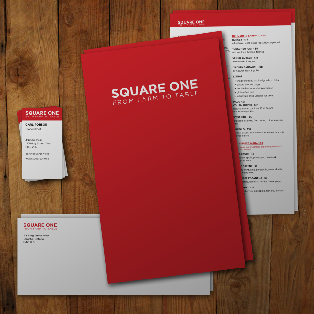 A restaurant menu from Square One placed on a wooden table with matching print pieces.