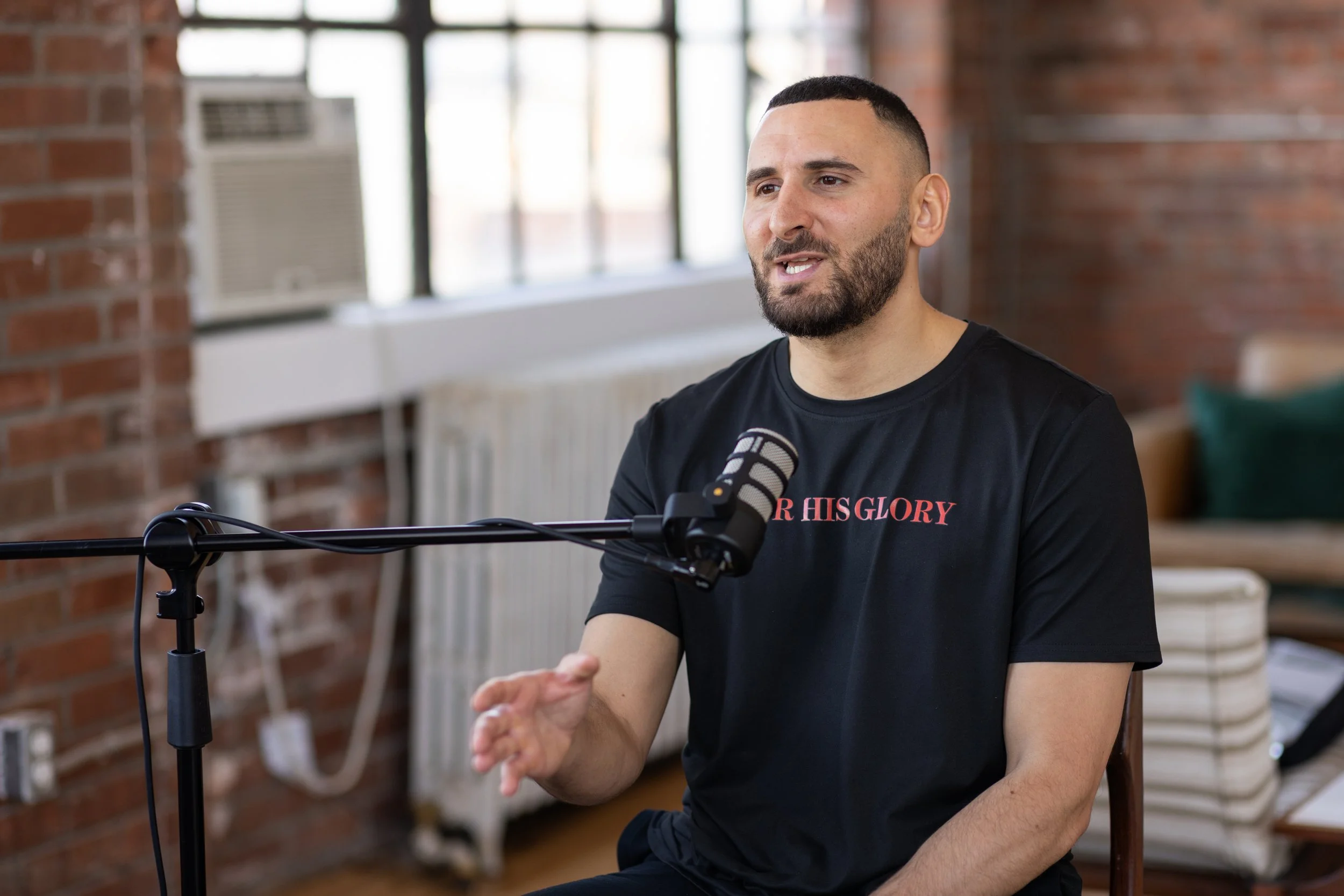 Stefano speaking into a podcast microphone in the studio.