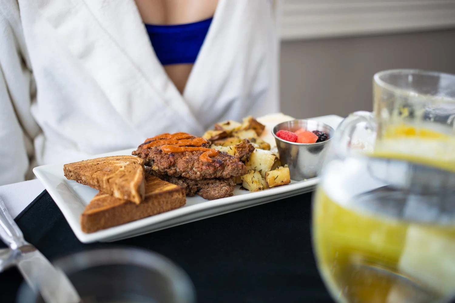 Breakfast plate with toast, biscuits and gravy, hash browns, and berries.